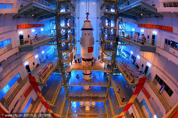 The Shenzhou VIII spacecraft is assembled with the Long-March II-F rocket at the Jiuquan Satellite Launch Center in Northwest China’s Gansu province on Oct 23, 2011. China to launch Shenzhou VIII early November