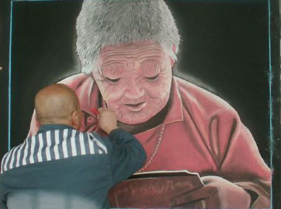 A prisoner draws on a blackboard in Xinyang Prison, November 2010. Prison, a special place of learning