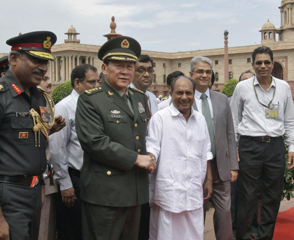 China's Defense Minister Liang Guanglie shakes hands with his Indian counterpart A. K. Antony (third from right) after their meeting in New Delhi on Tuesday. Liang's visit is expected to improve bilateral ties of the two neighboring countries. B Mathur / Reuters Military cooperation a sign of warmer relations