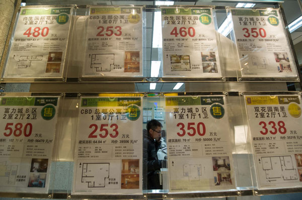 Houses for sale are advertised at a real estate agency in Beijing. The municipal government announced detailed rules on Saturday aimed at cooling the property market. LUO XIAOGUANG / XINHUA  2 cities in bid to cool real estate market