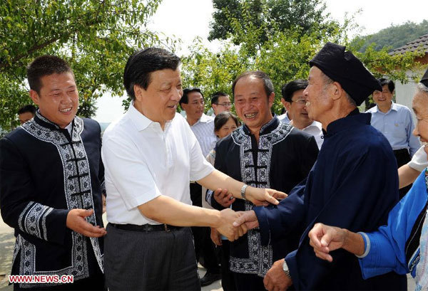 Liu Yunshan (2nd L), a member of the Standing Committee of the Political Bureau of the Communist Party of China (CPC) Central Committee, talks with locals at Wuluoba village in Qianxi county, Southwest China's Guizhou province, Aug 23, 2013.  Senior leader stresses improving CPC work style
