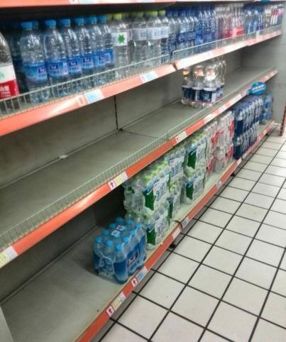 Bottled water left on shelves of super market. Stench sparks panic water buying in Hangzhou