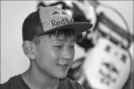 With a push from dad, boy motorcyclist flying high