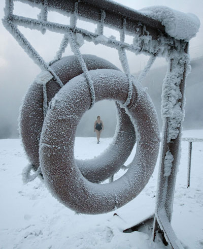 Lyubov Valiyeva, a member of the 'Cryophil' winter swimming club, walks on the bank of the Yenisei River with the temperature at -25 C in the Siberian city of Krasnoyarsk on Wednesday. Ilya Naymushin / Reuters Cold spell leaves 123 dead in Russia